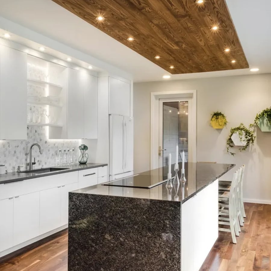 Luxury kitchen with dark cabinets and pendant lighting