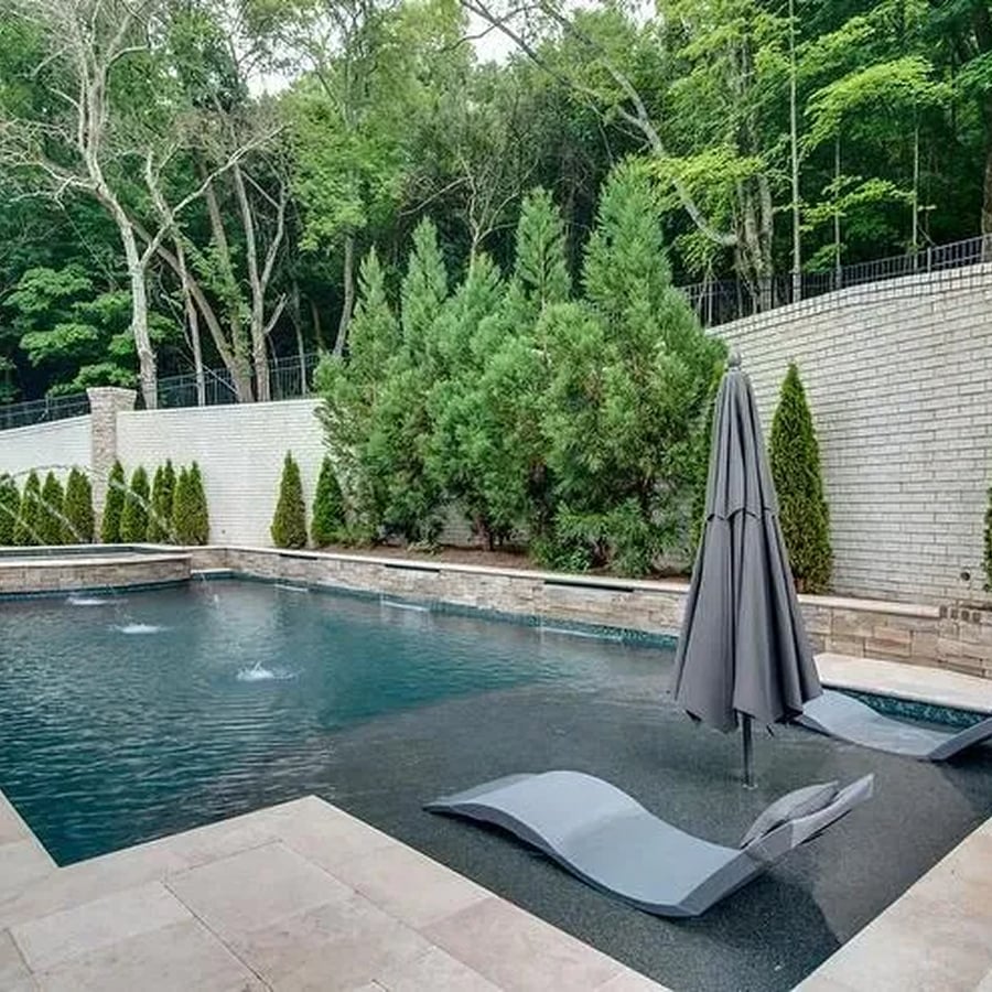 Custom swimming pool with blue LED lighting at night