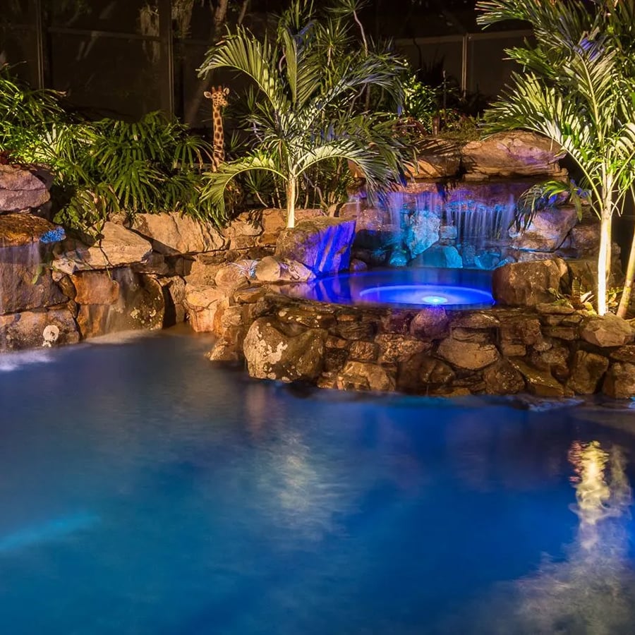 Resort-style swimming pool with landscaping